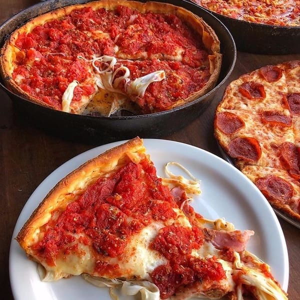 A deep-dish pizza in a cast iron pan, a slice on a plate, and a pepperoni pizza.